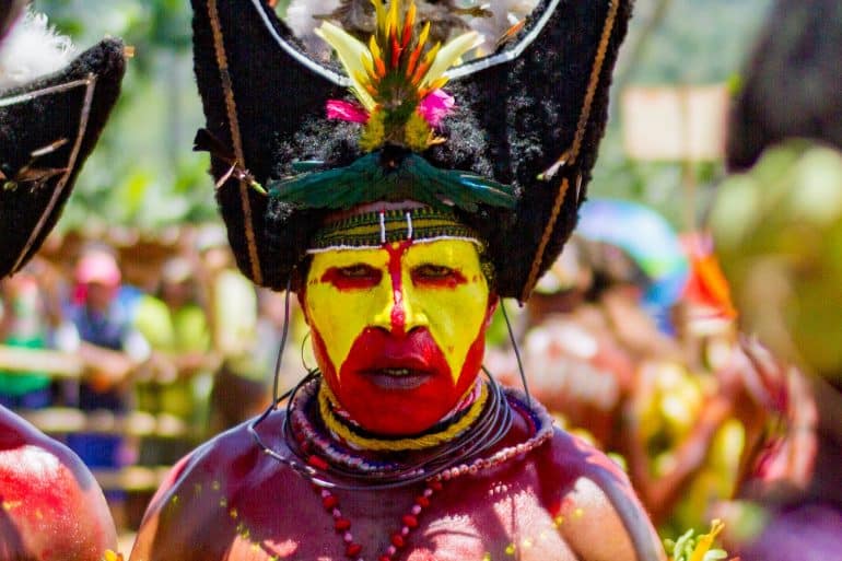 Photo of Papau New Guinea Man in headress by Jordan Donaldson for Unsplash