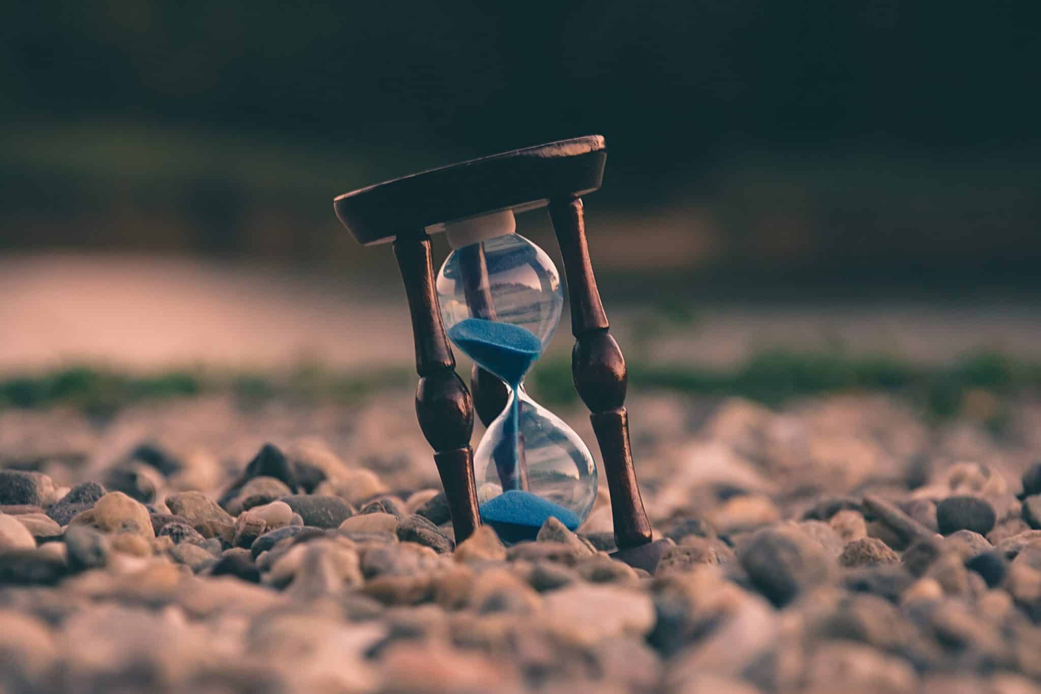 Photo of hourglass on rocks by by Aron Visuals on Unsplash