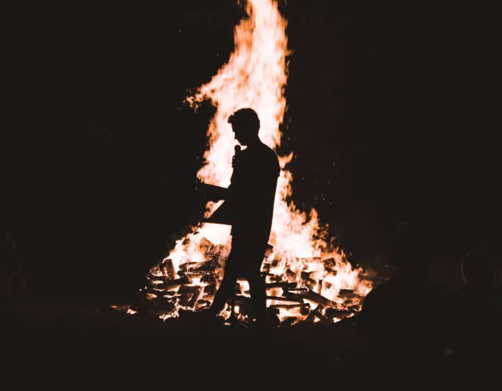 MAn standing in front of bonfire by Jordon Conner for Unsplash