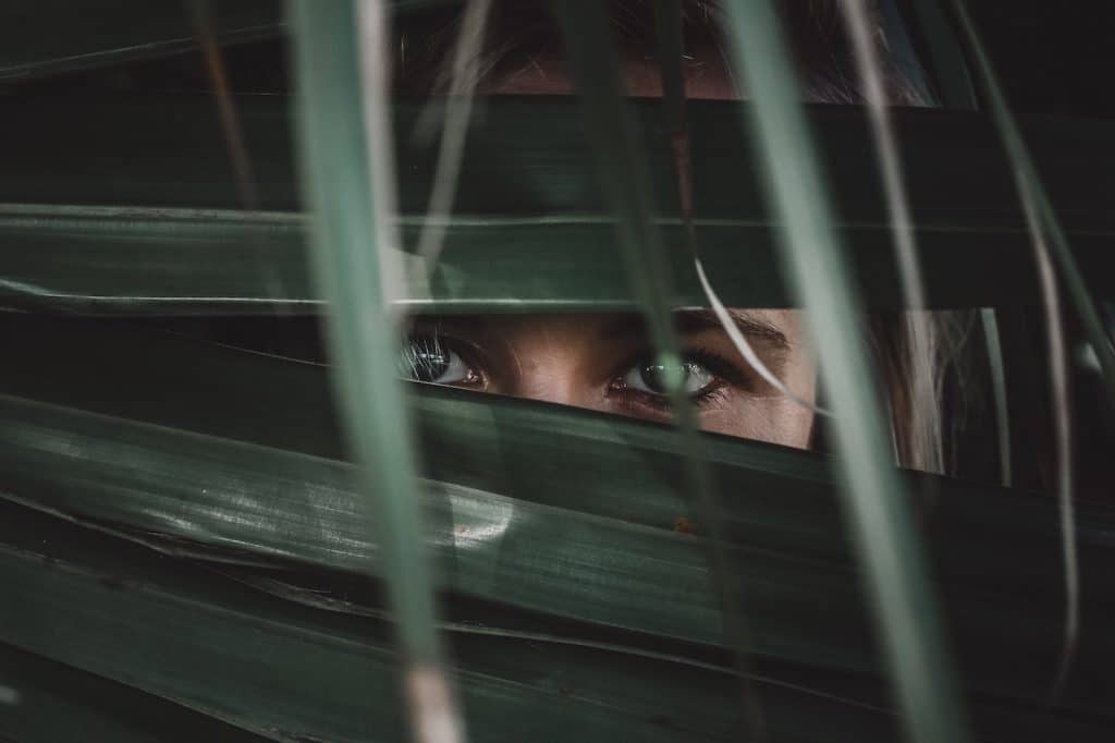 Image of woman behind leaves by KyleCut for Unsplash