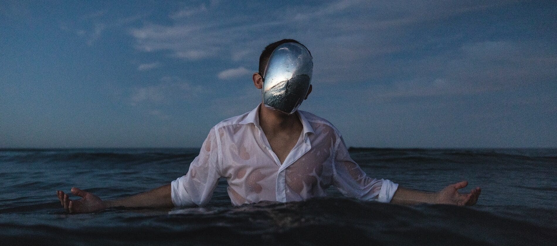 Photo of man in ocean with mask by Alex Iby for Unsplash