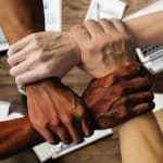 Photo of team hands holding arms by Tumisu for Pixabay