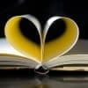 Photo of notebook with pages folded into a heart by cromaconceptovisual for Pixabay