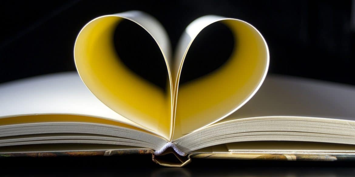 Photo of notebook with pages folded into a heart by cromaconceptovisual for Pixabay