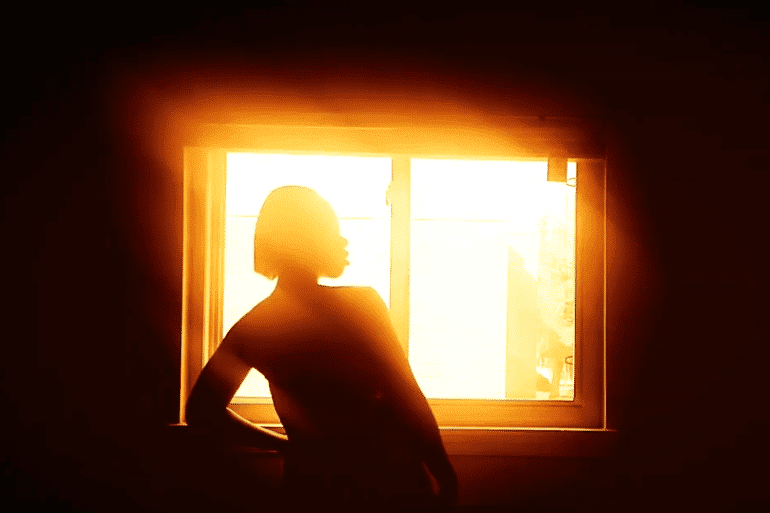 Photo of woman at window by Shanita Mitchell