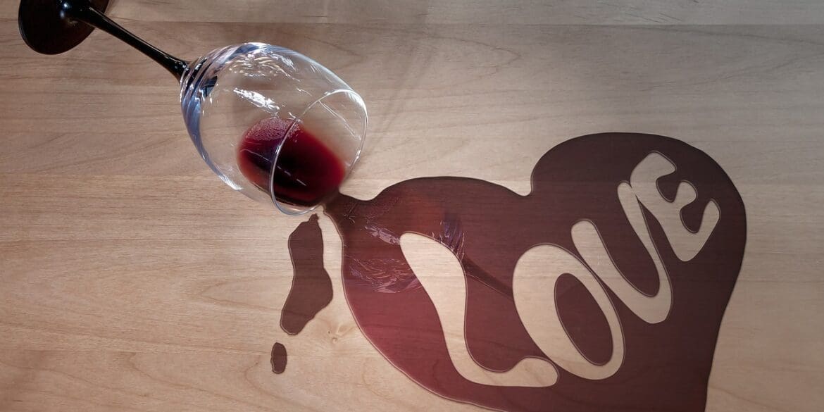 Image of spilled wine spelling love by JOEBU-art for Pixabay
